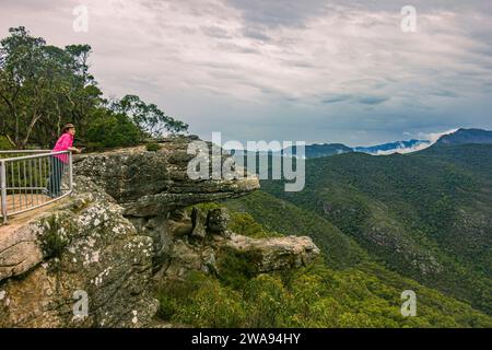 Eine Frau auf den Balkonen hält Ausschau nach dem Grampians-Nationalpark in Victoria, Australien. Stockfoto