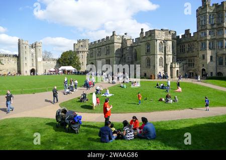 Warwick, England, Vereinigtes Königreich - 2. April 2017: Menschen, die sich im Garten von Warwick Castle entspannen und picknicken Stockfoto