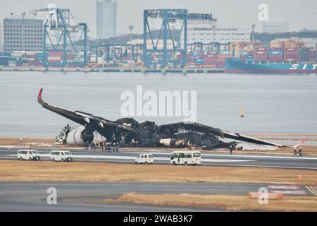 Tokio, Japan. Januar 2024. Beamte untersuchen ein verbranntes Flugzeug der Japan Airlines (JAL) Airbus A350 nach einer Kollision mit einem Flugzeug der japanischen Küstenwache MA722 Mizunagi (Bombardier DHC-8-300) am Flughafen Tokio (Haneda Airport) in Tokio, Japan am Mittwoch, 3. Januar 2024. Foto: Keizo Mori/UPI Credit: UPI/Alamy Live News Stockfoto