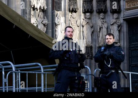 Polizisten an den Einlassschleusen vor dem Kölner Dom. Terroralarm zum Jahreswechsel: Nachdem Silvester rund um den Kölner Dom 1000 Polizisten auch mit Maschinenpistolen im Einsatz waren, werden die Sicherheitsregeln weiter aufrecht erhalten. Es gelten verstärkte Sicherheitsmaßnahmen nach einer Terrorwarnung vor Weihnachten. Hintergrund: Eine islamistische Terrorzelle des afghanischen ISIS-Ablegers ISPK soll über den Jahreswechsel u.a. in Köln Anschläge geplan haben. Für Touristen bleibt der Dom weiter geschlossen. Besucher von Messen oder lange im Vorfeld gebuchten Führungen müssen ein Screen Stockfoto