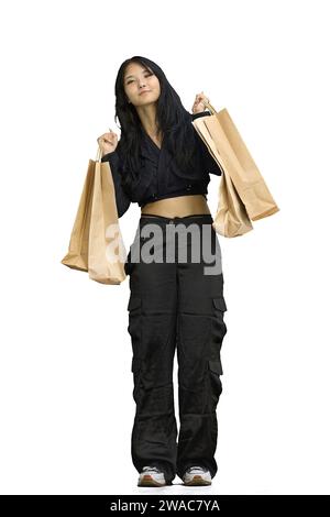 Eine Frau in schwarzer Kleidung, auf weißem Hintergrund, in voller Länge, mit Taschen Stockfoto