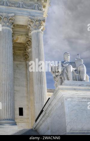 Eine dramatische Nahaufnahme der sitzenden Marmorstatue „Guardian“ im Vordergrund der neoklassischen Architektur des Obersten Gerichtshofs der USA, Washington DC Stockfoto