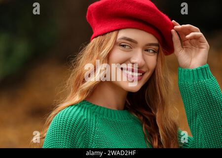 Porträt einer lächelnden Frau, die draußen einen Herbstpullover trägt Stockfoto