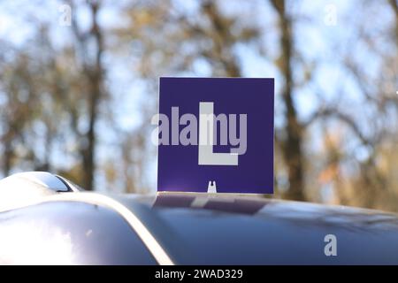 L-Schild auf dem Autodach im Freien. Fahrschule Stockfoto