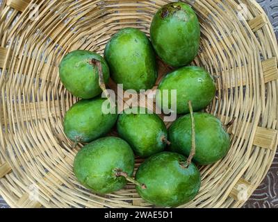 Grüne Mango, im Korb in Indien Sommerfrucht, indische grüne Mango Stockfoto
