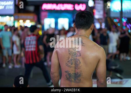 PHUKET, THAILAND - 25. APRIL 2023: Tätowierung auf dem Rücken eines Mannes in der Patong Beach Bangla Walking Street in der Nacht. Stockfoto