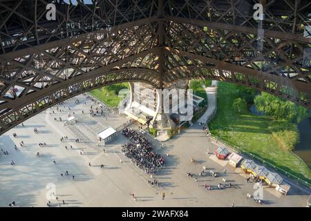 Paris, Frankreich - 21. April 2017: Eiffelturm, Details der Beinstruktur und lange Warteschlange für den Eintritt Stockfoto