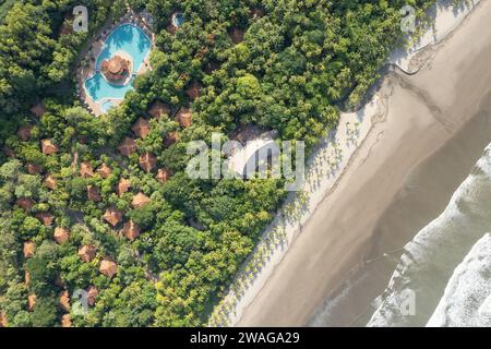 Tropische Resortvillen neben dem Ozean Strand mit Blick auf die Drohne Stockfoto