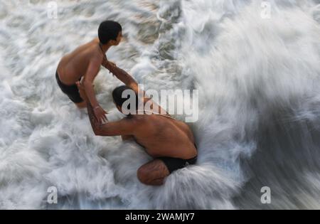 Ayodhya, Indien. Dezember 2023. Gläubige nehmen ein Bad im Wasser des Sarayu River. Die antike Stadt Ayodhya liegt am Ufer des Flusses Sarayu und ist der Geburtsort von Lord RAM und gilt als sehr religiös. (Foto: Biplov Bhuyan/SOPA Images/SIPA USA) Credit: SIPA USA/Alamy Live News Stockfoto