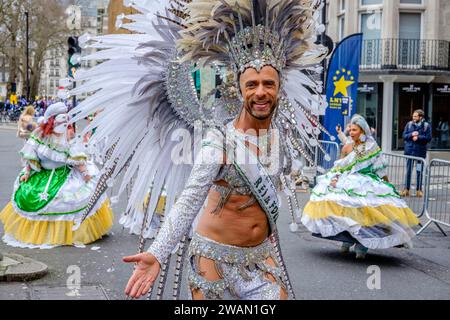 Mitglieder der London School of Samba machen sich auf den Weg zum Start der Strecke für die London New Year's Day Parade 2024. Stockfoto