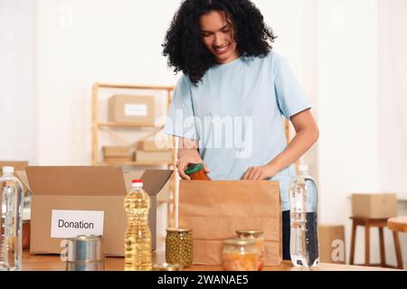Freiwilliger Verpacken von Lebensmitteln am Tisch im Lager Stockfoto