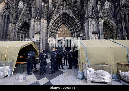 Polizisten rund um den Kölner Dom. Terroralarm zum Jahreswechsel: Nachdem Silvester rund um den Kölner Dom 1000 Polizisten auch mit Maschinenpistolen im Einsatz waren, werden die Sicherheitsregeln weiter aufrecht erhalten. Es gelten verstärkte Sicherheitsmaßnahmen nach einer Terrorwarnung vor Weihnachten. Hintergrund: Eine islamistische Terrorzelle des afghanischen ISIS-Ablegers ISPK soll über den Jahreswechsel u.a. in Köln Anschläge geplan haben. Für Touristen bleibt der Dom weiter geschlossen. Besucher von Messen oder lange im Vorfeld gebuchten Führungen müssen ein Screening in Zelten durchl Stockfoto