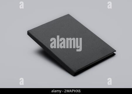 Leeres graues, schwimmendes Buchmodell. Studio-Aufnahme eines leeren geschlossenen Buches, das mit Schatten darunter auf weißem Hintergrund schweben kann. 3D Stockfoto