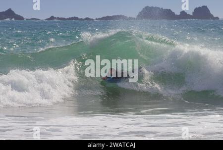 Boarder, der den Break in Kynance Cove, Cornwall, schnappt. Wird bald gelöscht. Stockfoto