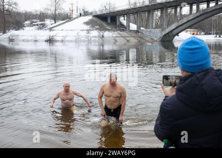 Kiew, Ukraine. Januar 2024. Die Menschen kommen aus dem Wasser, nachdem sie im kalten Fluss Dnipro geschwommen sind, anlässlich der Feier der Epiphanik in Kiew. Die Ukraine feiert in diesem Jahr erstmals die Epiphanik am 6. Januar nach dem westlichen Kalender und weicht von der Tradition der russisch-orthodoxen Kirche ab, sie am 19. Januar zu feiern. Während der Epiphanienzeit glauben manche, dass das Wasser besondere heilende Eigenschaften hat und zur Behandlung verschiedener Krankheiten verwendet werden kann, und viele von ihnen nehmen im Rahmen der Epiphanienfeier ein Bad im Wasser. (Credit Image: © Oleksii Chumachenko/SOPA Images via Z Stockfoto