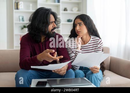 Budgetplanung. Gestresste Millennial-Indische Ehegatten, Die Papiere Halten Stockfoto