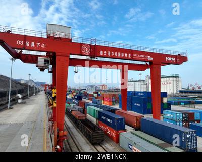 LIANYUNGANG, CHINA - 8. JANUAR 2024 - Großmaschinen beladen Container für den Güterzug China-Kasachstan (Lianyungang) auf der China-Kasachstan l Stockfoto