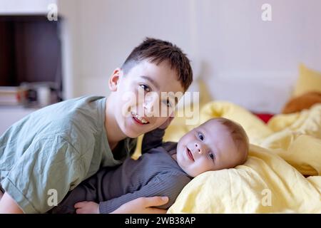 Glückliche Familie, neugeborenes Baby und ältere Brüder, Mutter zu Hause zu Weihnachten Stockfoto