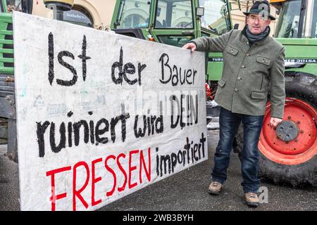 Hubert Aiwanger, stellvertretender Bayerischer Ministerpräsident, bei Großkundgebung des Bauernverbands, München, 8. Januar 2024 Deutschland, München, 8. Januar 2024, Hubert Aiwanger, stellvertretender Bayerischer Ministerpräsident, posiert mit Protestplakat ist der Bauer ruiniert, wird dein Fressen importiert, bei Großkundgebung des Bayerischen Bauernverbands gegen Agrarkürzungen, Demo ab 11 HR auf dem Odeonsplatz, Wut gegen geplante Streichung der Agrardiesel Vergütung, Agrardiesel-Subventionen, die Bundesregierung will Landwirten die Steuervergünstigungen, Landwirtschaft, Sparpoli Stockfoto