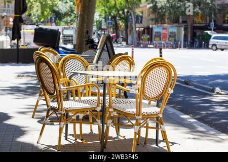Sonnige Cafe-Terrasse in Barcelona, leerer Tisch mit Stühlen draußen auf der Straße Stockfoto