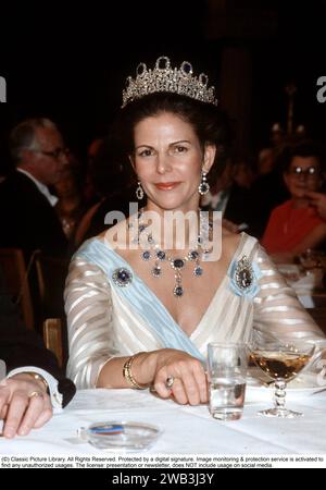 Königin Silvia von Schweden. Ehefrau des heutigen schwedischen Königs Carl XVI. Gustaf. 1981 beim Nobelessen mit dem Leuchtenberg-Saphir-Set erbte Königin Josefina von Schweden den Schmuck von ihrer Mutter Augusta Amalia, Herzogin von Leuchtenberg. Der Schmuck wurde vermutlich von Marie-Etienne Nitot in Paris hergestellt. Danach ging der Schmuck an Königin Sofia, aber es ist nicht belegt, dass sie das Set trug. Außerdem war Königin Victoria die letzte, die sie privat besaß. Die Leuchtenberg-Saphire. Diadem-Set mit Saphiren und Brillanten in 11 Gelenkteilen. 7 cm hoch, 40,5 cm lang. Stockfoto