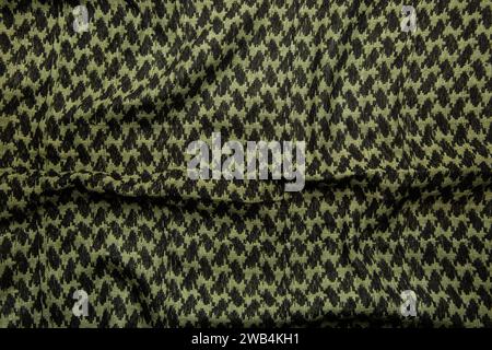 Keffieh Schal. Die Textur des traditionellen Baumwoll-symbolischen arabischen Schals. Khaki Hintergrund. Stockfoto