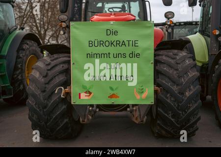 Kaiserslautern, Deutschland. Januar 2024. Traktor mit Protestschild am Messeplatz. Deutsche Bauern trafen sich in verschiedenen Teilen des Landes, um gegen die Pläne der Regierung zu protestieren, Agrarsubventionen zu reduzieren. Der bundesweite Protest wurde vom Deutschen Bauernverband (DBV) ab Montag, dem 8. Januar, initiiert und in der Woche fortgesetzt. Ziel ist es, das Bewusstsein zu erhöhen, indem Straßen mit landwirtschaftlichen Fahrzeugen blockiert und in Städten präsent sind. Die Demonstrationen werden zu schweren Staus in und um verschiedene Städte führen. Gustav Zygmund/Alamy News Stockfoto