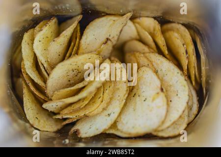 Im Inneren befindet sich eine offene Packung Kartoffelchips. Fettes Junk Food Snack Point. Paket. Eine offene Packung Chips. Blick von oben. Draufsicht. Stockfoto