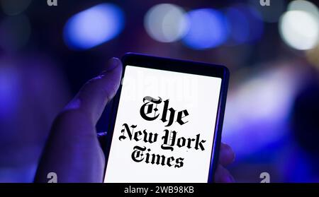 Dhaka, Bangladesch – 09. Januar 2024: Hände halten ein Smartphone mit dem Logo der New York Times auf dem Bildschirm. Die New York Times ist eine US-amerikanische Zeitung. Stockfoto