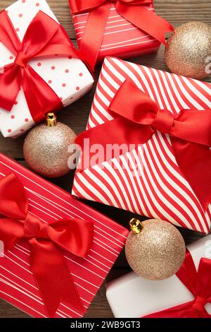 Weihnachtshintergrund mit Geschenkboxen und Weihnachtskugeln. Draufsicht mit Kopierbereich. Stockfoto