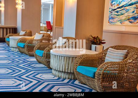 Moderne Wicker Lounge in der Hotellobby mit künstlerischen Akzenten Stockfoto