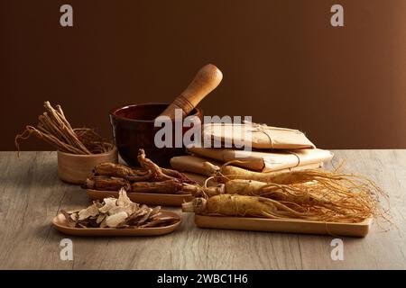 Vorderansicht der Ginsengwurzeln auf Tablett, Rhizoma rhe und codonopsis pilosula auf Holztisch. Gesunde Kräuter. Werbeszenen für Traditiona Stockfoto