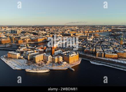 Panorama der Altstadt von Stockholm, der Insel Riddarholmen und der Innenstadt, im Winter mit Schnee und hellem Sonnenschein. Blickwinkel der Drohne. Stockfoto