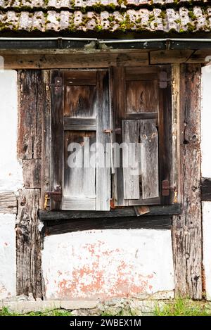 Alte kaputte Fenster und Fassade eines Landhauses auf dem Land. Stockfoto