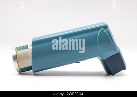 Blauer Asthma-Inhalator mit leerem Etikett isoliert auf weißem Hintergrund. Arzneimittel werden zur Behandlung oder Vorbeugung von Asthmaanfällen angewendet. Gesundheit und Stockfoto