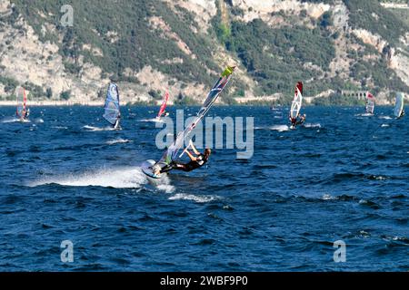 Windsurfer beim Surfen bei starkem Wind am Gardasee in der Nähe von Malcesine, Veneto, Italien Stockfoto