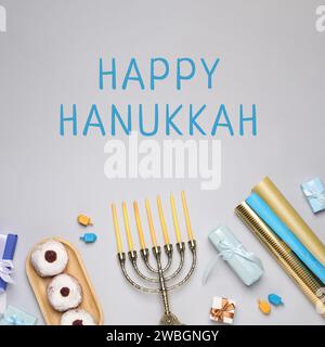 Happy Hanukkah. Menora, Donuts, Geschenke und Dreidels auf hellem Hintergrund, flach Stockfoto