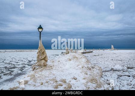 Lake Erie Pier in Ontario, Kanada, mit Eispfosten bedeckt. Natürliche Eisskulpturen, die aus Wellen während eines Wintersturms entstanden sind Stockfoto