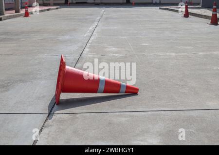 Orangefarbene Verkehrskegel auf Betonstraße Stockfoto