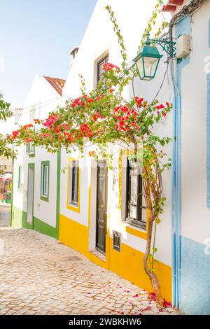 Ferragudo, Algarve, Portugal.26. september 2020. Traditionelle weiße Häuser mit Ziegeldächern in engen Gassen, die mit Bougainvillea-Blumen im geschmückt sind Stockfoto