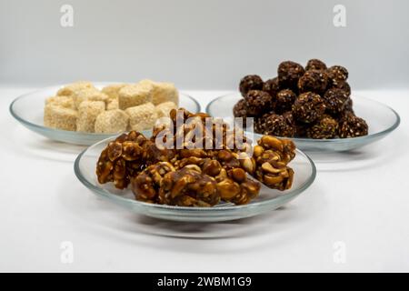 Drei Teller voller Sesam Ladoo, Til Ko Laddu, Jaggery Peanuts Laddoo für Maghe Sankranti und Makar Sankranti Festival in Nepal und Indien Stockfoto