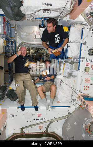 Drei Astronauten an Bord der Internationalen Raumstation im Knoten Unity werden während einer Snackpause fotografiert. Zur Besatzung gehören die NASA-Astronauten Mark Kelly und Greg Chamitoff, der STS-134-Kommandeur und Missionsspezialist, sowie der ESA-Astronaut Roberto Vittori, Missionsspezialist. Expedition 27 Flugingenieur Cady Coleman ist im Hintergrund. Stockfoto