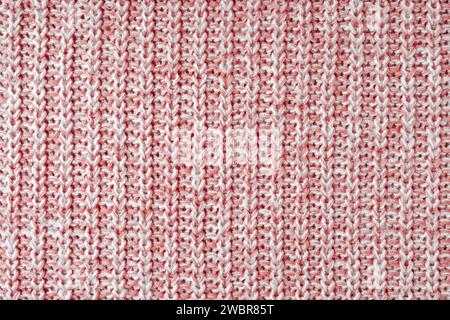 Jersey Textil Hintergrund, rot weiß meliert gestrickter Wollstoff. Strickwaren aus Wolle, Pullover, Oberflächenbeschaffenheit des Pullovers, Textilstruktur, Stoffoberfläche Stockfoto