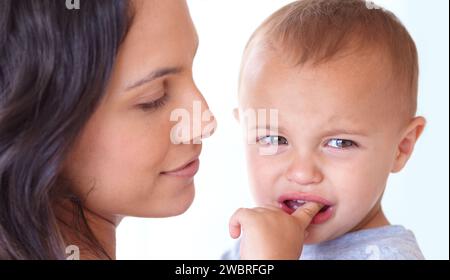 Familie, Weinen und Mutter mit Baby auf weißem Hintergrund für Bindung, Empathie und Komfort. Liebe, Jugend und Mutter mit traurigem oder verärgertem Kind für eine Beziehung Stockfoto