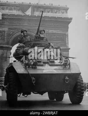PARIS, FRANKREICH - August 1944: Soldaten der US-Armee in einem leichten gepanzerten M8 fahren während der Befreiung von Pa auf den Champs Elysées im Zentrum von Paris Stockfoto