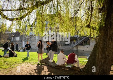 Obwohl Cambridge für seine renommierte Universität bekannt ist, ist es auch eine der ungleichsten Städte in Großbritannien. In Bezug auf den Reichtum besteht ein alarmierendes Ungleichgewicht zwischen „Stadt und Kleid“. Japanische Touristen genießen einen Nachmittag am Ufer des Flusses Cam, der durch die Stadt verläuft. Stockfoto