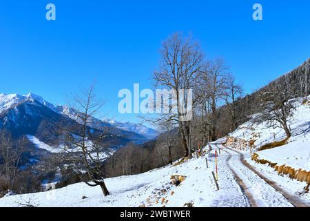 Schneebedeckte Route in den Karavanke-Bergen oberhalb von Kranjska Gora mit dem Mangart-Berg in den Julischen alpen, Gorenjska, Slowenien Stockfoto