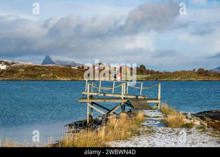 Bootssteg, Anlegestelle, Bootssteg mit farbigen Häusern am Ufer des Nordatlantiks. Bootshaus und hölzernes Ferienhaus auf den Inseln von Kvaløya, Norwegen Stockfoto