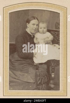 Porträt einer Frau mit einem Baby, M. Frankfurter, um 1850 - um 1900 Fotografie. Besuchskarte Teil des Fotoalbums einer niederländischen Familie mit 168 Cartes de-Visiting- und Kabinettfotos. Arnheim-Karton. Papier. Fotografischer Trägeralbumendruck historischer Personen. studiobedarf  Fotograf. Kleidung für den oberen Teil des Körpers. Kleidung für den unteren Teil des Körpers. Kleidung, die den ganzen Körper bedeckt. Haarkleid. Säugling, Baby  das Alter des Menschen. Brosche, Agraffe, schließe Bocholt (Deutschland) Stockfoto