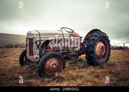 Ein alter rostiger Traktor in schlechtem Zustand auf einer Weide in Island. Stockfoto